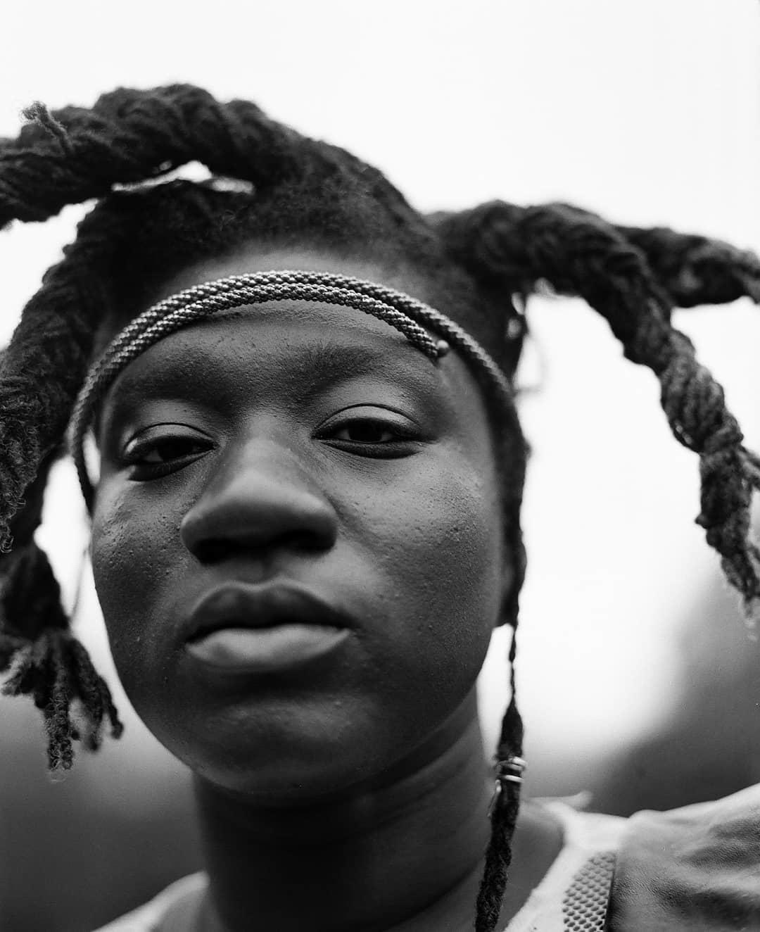 Black and white photograph of a woman with dread locks and headband